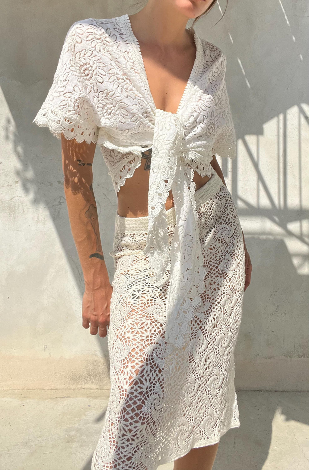 Top pizzo bianco con maniche annodato sul davanti
